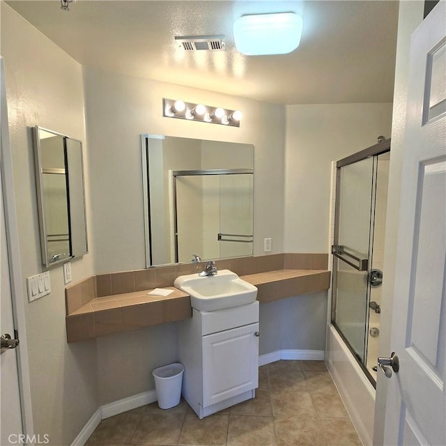 2742 Cabrillo Ave Unit 201, Torrance, CA 90501 - bathroom featuring bath / shower combo with glass door, vanity, tile patterned flooring, and baseboards