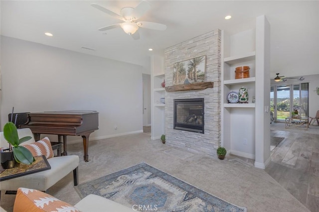 38550 Crossover Rd, Temecula, CA 92592 - carpeted living room with ceiling fan, a stone fireplace, baseboards, recessed lighting, and built in shelves