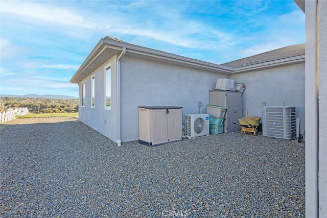 38550 Crossover Rd, Temecula, CA 92592 - view of side of home with stucco siding, ac unit, and cooling unit