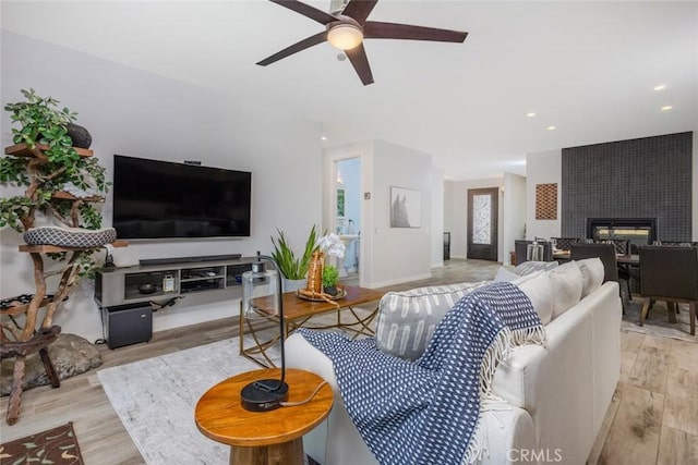 38550 Crossover Rd, Temecula, CA 92592 - living area featuring wood finished floors, ceiling fan, a tiled fireplace, baseboards, and recessed lighting