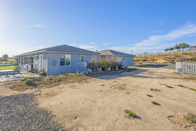 38550 Crossover Rd, Temecula, CA 92592 - view of front of house with fence, a patio area, and stucco siding