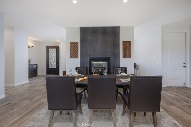38550 Crossover Rd, Temecula, CA 92592 - dining area featuring light wood finished floors, a tile fireplace, baseboards, recessed lighting, and a chandelier