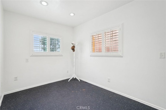 unfurnished room featuring baseboards and recessed lighting