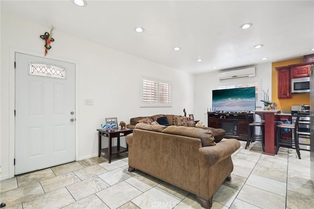 living room featuring an AC wall unit and recessed lighting