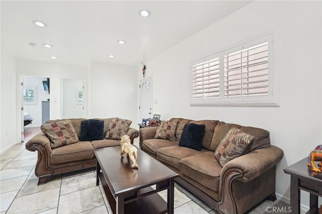 living room with recessed lighting, baseboards, and light tile patterned floors