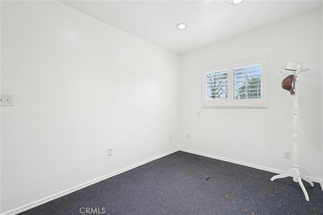 unfurnished room with baseboards and recessed lighting