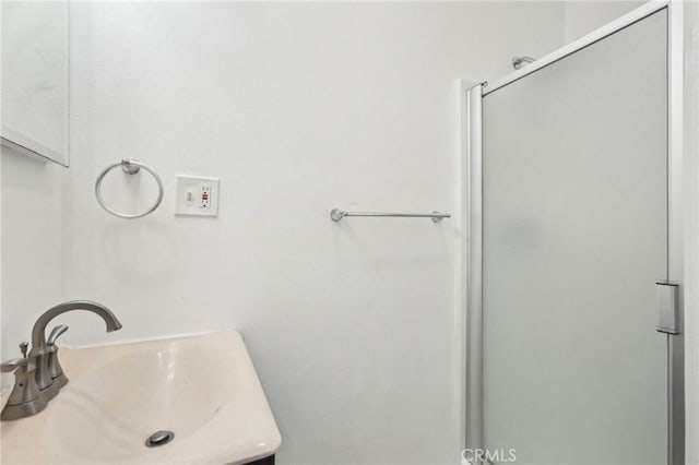 bathroom featuring a shower stall and vanity