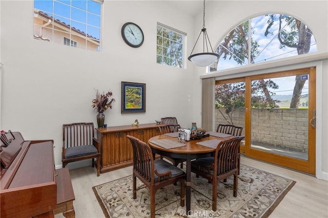 744 Clearview Ln, San Luis Obispo, CA 93405 - dining area featuring a towering ceiling, light wood-style flooring, and baseboards