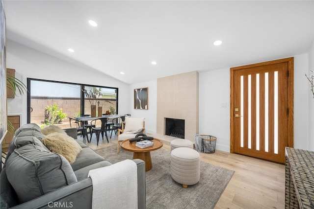 16009 Jalon Rd, La Mirada, CA 90638 - living room with a tiled fireplace, light wood-style floors, lofted ceiling, and recessed lighting