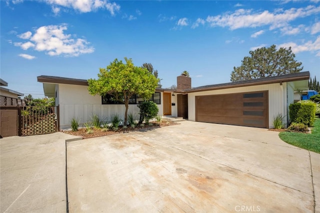 16009 Jalon Rd, La Mirada, CA 90638 - view of front of house with an attached garage, a chimney, driveway, and fence