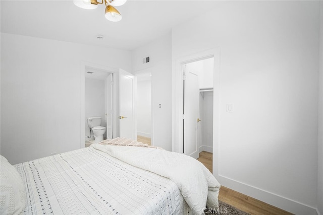 16009 Jalon Rd, La Mirada, CA 90638 - bedroom with a walk in closet, light wood-type flooring, baseboards, and ensuite bath