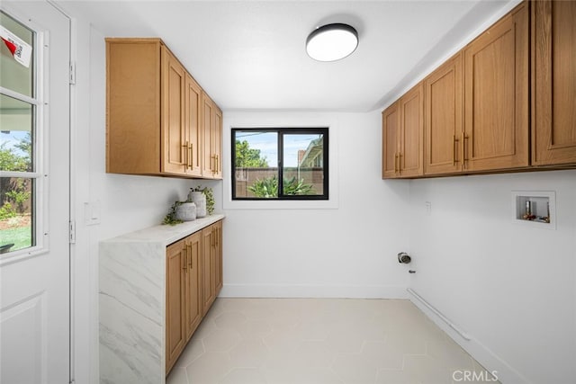16009 Jalon Rd, La Mirada, CA 90638 - laundry area featuring cabinet space, hookup for a washing machine, baseboards, and light tile patterned flooring