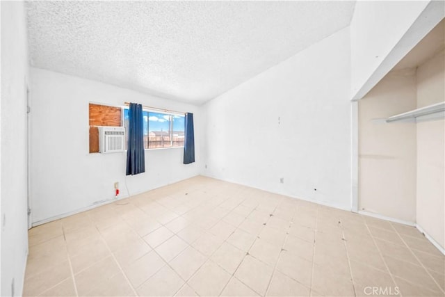 unfurnished room with a textured ceiling and cooling unit