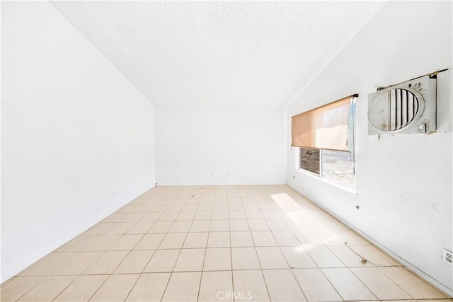 spare room with lofted ceiling and a textured ceiling