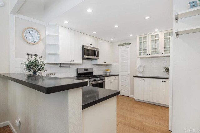 1715 Kennington Rd, Encinitas, CA 92024 - kitchen featuring stainless steel appliances, open shelves, dark countertops, white cabinetry, and recessed lighting