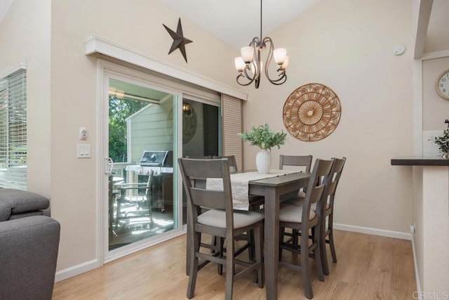 1715 Kennington Rd, Encinitas, CA 92024 - dining space featuring light wood-type flooring, vaulted ceiling, a chandelier, and baseboards