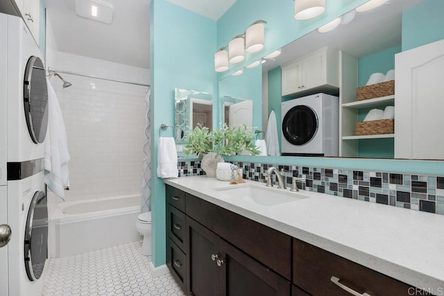 1715 Kennington Rd, Encinitas, CA 92024 - full bathroom featuring stacked washer / drying machine, toilet, backsplash, shower / bath combo with shower curtain, and vanity