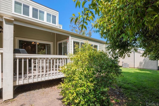 1715 Kennington Rd, Encinitas, CA 92024 - view of property exterior featuring a deck, a lawn, and central AC
