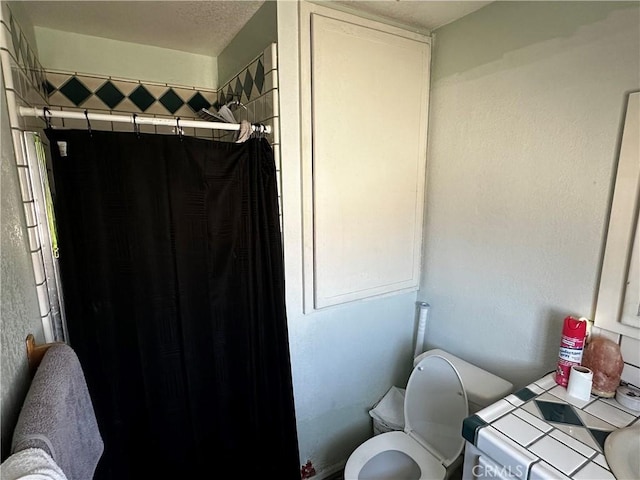 351 Armory Rd, Barstow, CA 92311 - bathroom featuring toilet and a shower with shower curtain