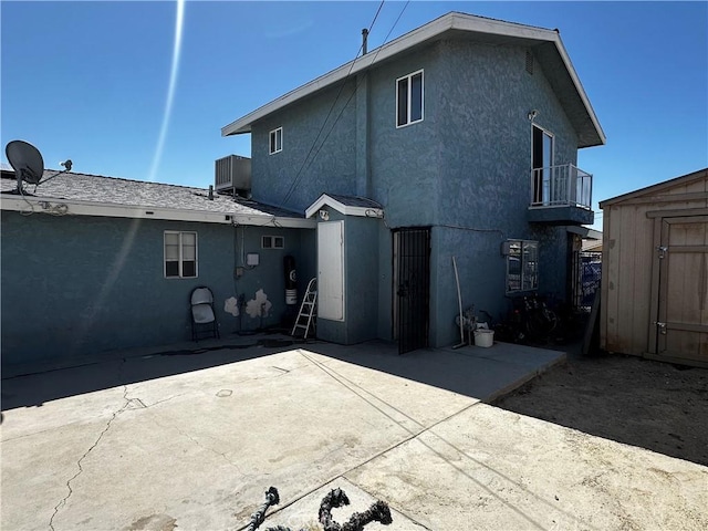 351 Armory Rd, Barstow, CA 92311 - back of property featuring stucco siding, central AC unit, a patio area, and a balcony