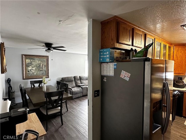 351 Armory Rd, Barstow, CA 92311 - kitchen with freestanding refrigerator, wood finished floors, a ceiling fan, brown cabinets, and dishwasher