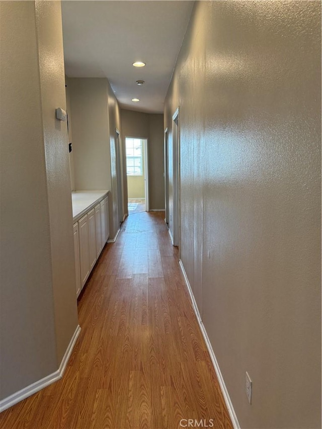 11946 Russell Ct, Victorville, CA 92392 - corridor with wood finished floors, baseboards, and recessed lighting