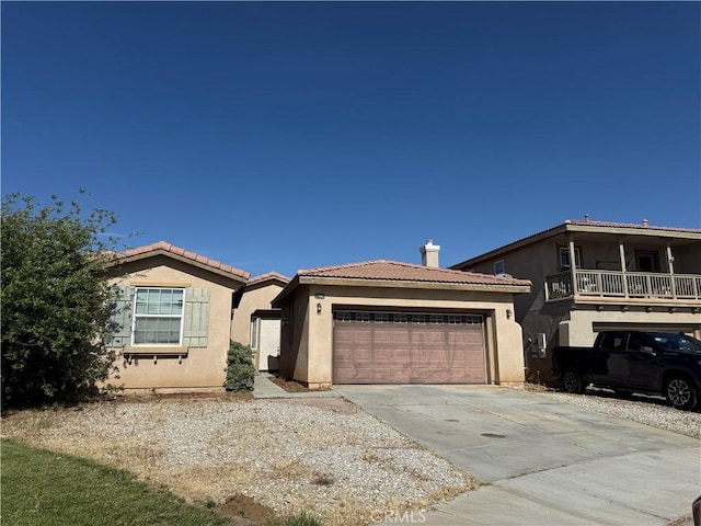 11946 Russell Ct, Victorville, CA 92392 - view of front of property with stucco siding, driveway, a garage, and a tiled roof