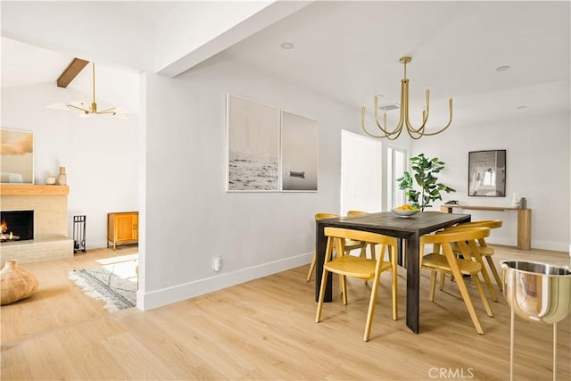 6340 Charlwood St, Lakewood, CA 90713 - dining space featuring a chandelier, light wood-type flooring, baseboards, and a fireplace