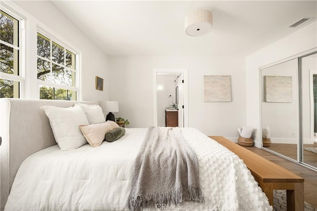 6340 Charlwood St, Lakewood, CA 90713 - bedroom featuring wood finished floors, a closet, ensuite bath, and baseboards