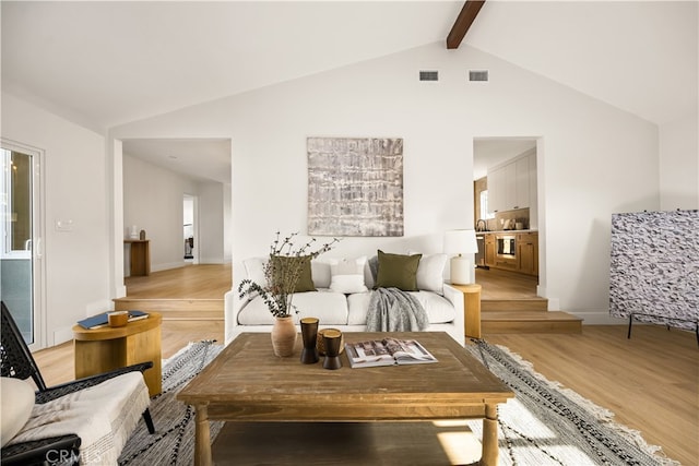 6340 Charlwood St, Lakewood, CA 90713 - living area with light wood-type flooring, beam ceiling, and high vaulted ceiling