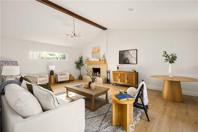 6340 Charlwood St, Lakewood, CA 90713 - living area featuring light wood-style flooring, a chandelier, baseboards, and a warm lit fireplace