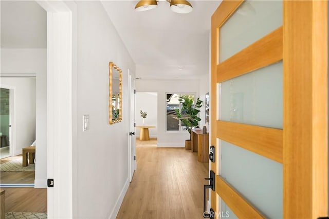 6340 Charlwood St, Lakewood, CA 90713 - hall featuring light wood-style flooring, baseboards, and a chandelier