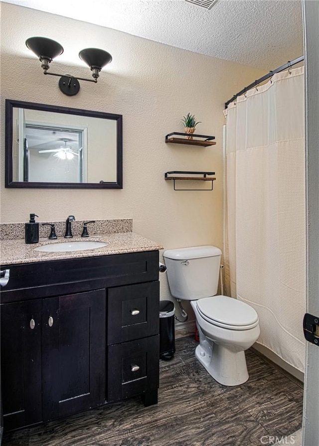 28071 Caldaro, Laguna Niguel, CA 92677 - full bathroom featuring wood finished floors, toilet, vanity, a textured ceiling, and ceiling fan