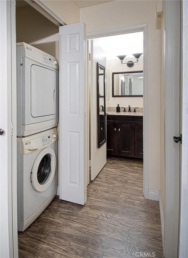 28071 Caldaro, Laguna Niguel, CA 92677 - washroom featuring stacked washer and clothes dryer and dark wood-style floors