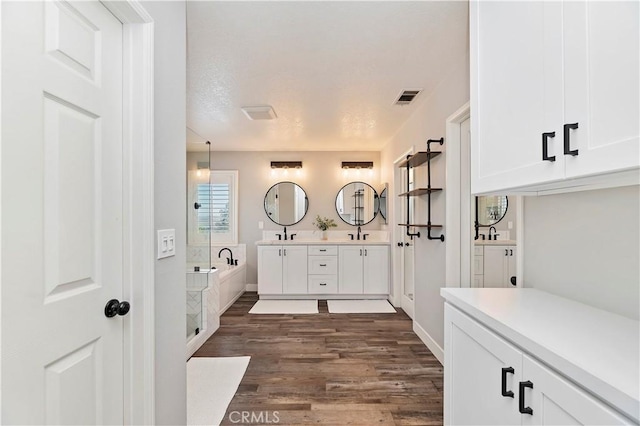 1663 Spyglass Dr, Corona, CA 92883 - bathroom with wood finished floors, a garden tub, and double vanity