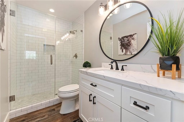 1663 Spyglass Dr, Corona, CA 92883 - full bath with wood finished floors, toilet, a shower stall, vanity, and recessed lighting