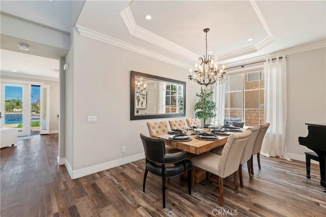 1663 Spyglass Dr, Corona, CA 92883 - dining room with healthy amount of natural light, a raised ceiling, a chandelier, ornamental molding, and baseboards