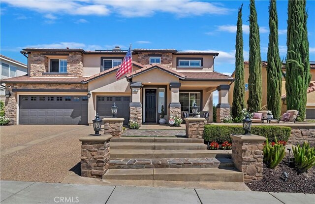 1663 Spyglass Dr, Corona, CA 92883 - view of front of house with stucco siding, stone siding, an attached garage, driveway, and a porch