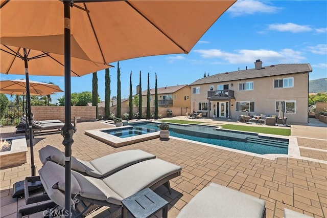 1663 Spyglass Dr, Corona, CA 92883 - view of swimming pool featuring a patio area, a fenced backyard, a pool with connected hot tub, and a residential view