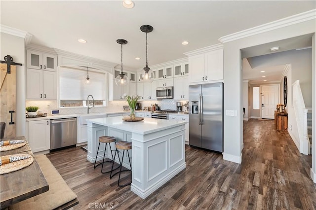 1663 Spyglass Dr, Corona, CA 92883 - kitchen featuring stainless steel appliances, white cabinets, a center island, tasteful backsplash, and light countertops