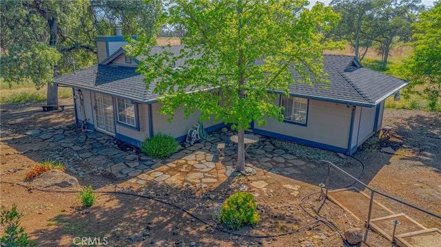 5030 Creek Front Rd, Catheys Valley, CA 95306 - view of front of home featuring roof with shingles, a patio area, and a chimney