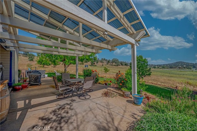 5030 Creek Front Rd, Catheys Valley, CA 95306 - view of patio / terrace with outdoor dining space, a pergola, and a rural view