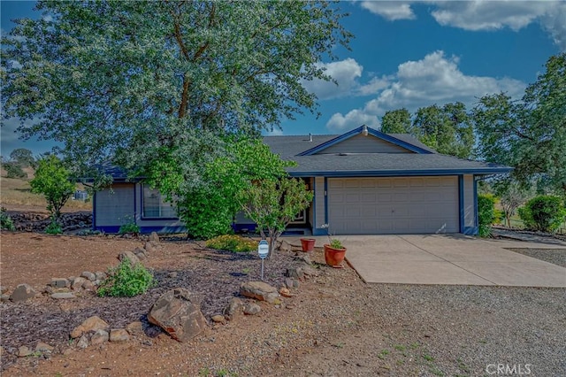 5030 Creek Front Rd, Catheys Valley, CA 95306 - view of front facade featuring concrete driveway, an attached garage, and a shingled roof