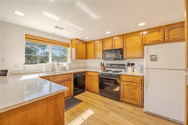 5030 Creek Front Rd, Catheys Valley, CA 95306 - kitchen featuring black appliances, a sink, light countertops, brown cabinets, and recessed lighting