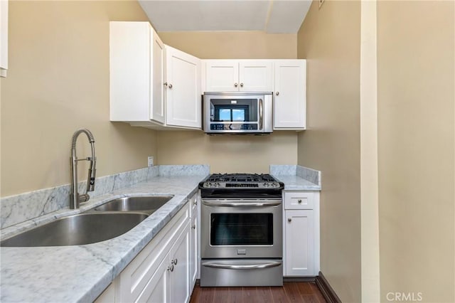 315 W 3rd St Unit 311, Long Beach, CA 90802 - kitchen featuring stainless steel appliances, a sink, dark wood-style floors, and white cabinetry