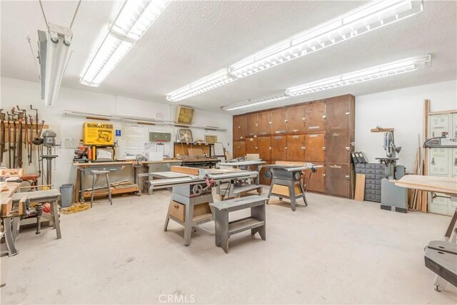 22935 Nadine Cir Unit A, Torrance, CA 90505 - dining room featuring a workshop area, a textured ceiling, and concrete flooring