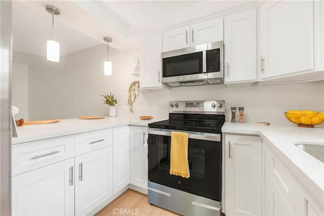 22935 Nadine Cir Unit A, Torrance, CA 90505 - kitchen with appliances with stainless steel finishes, white cabinetry, light countertops, pendant lighting, and light wood finished floors