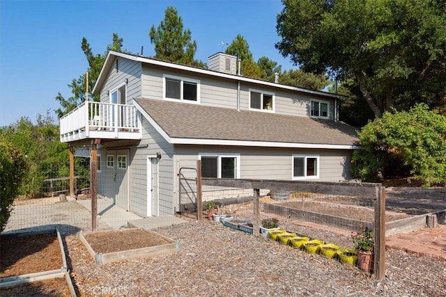 225 Hacienda Ave, San Luis Obispo, CA 93401 - view of front of house featuring a garden, a chimney, a shingled roof, and a wooden deck