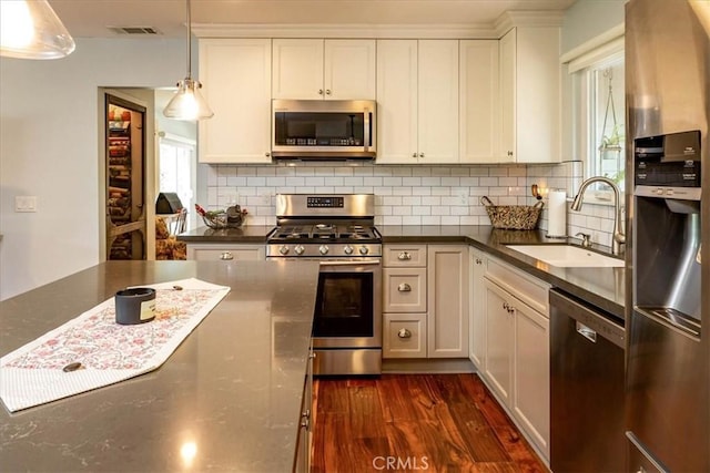 225 Hacienda Ave, San Luis Obispo, CA 93401 - kitchen with stainless steel appliances, a sink, dark countertops, and tasteful backsplash