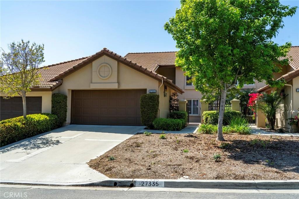27335 Paseo Laguna, San Juan Capistrano, CA 92675 - view of front of house featuring an attached garage, stucco siding, driveway, and a tiled roof